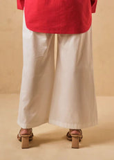 A Model Wearing White Organic Cotton The Jellyfish organic cotton trousers, curated by Only Ethikal